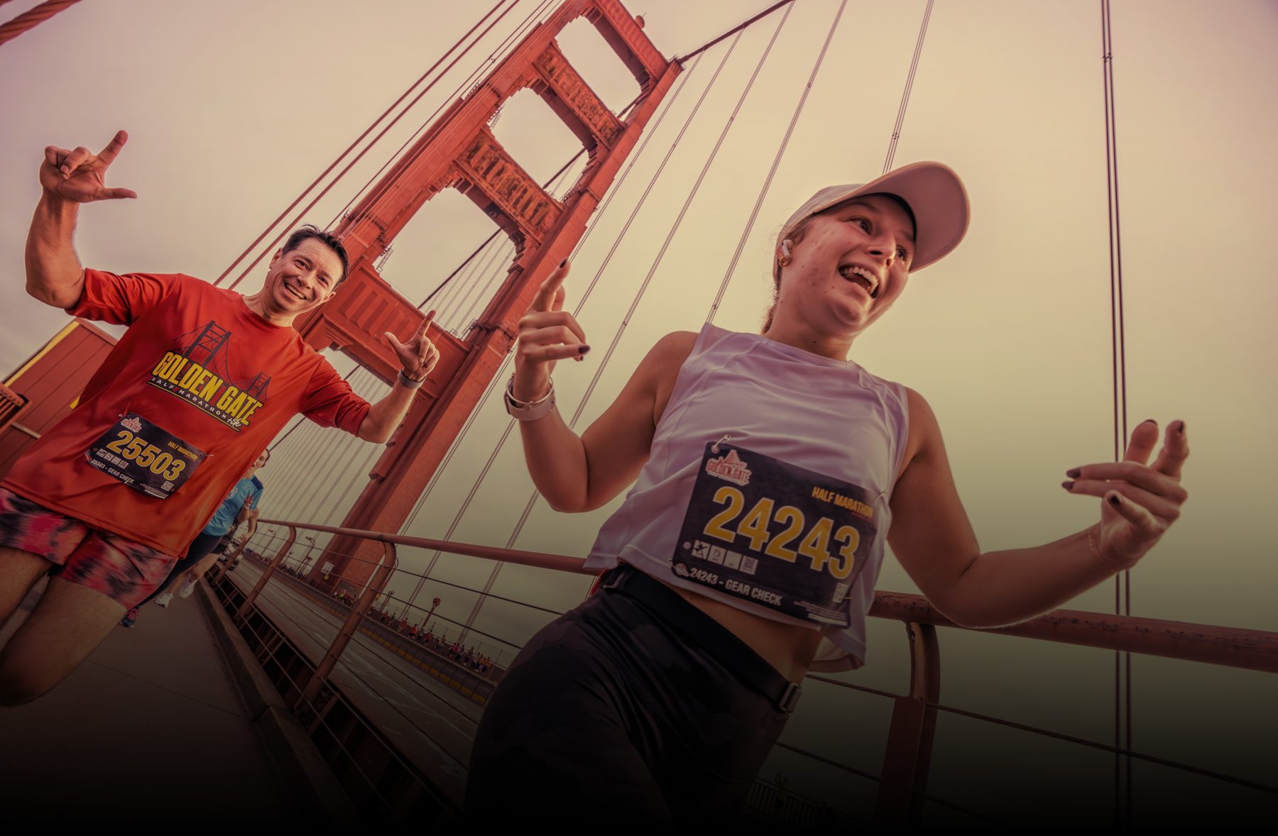 Two runners celebrating on the Golden Gate Bridge